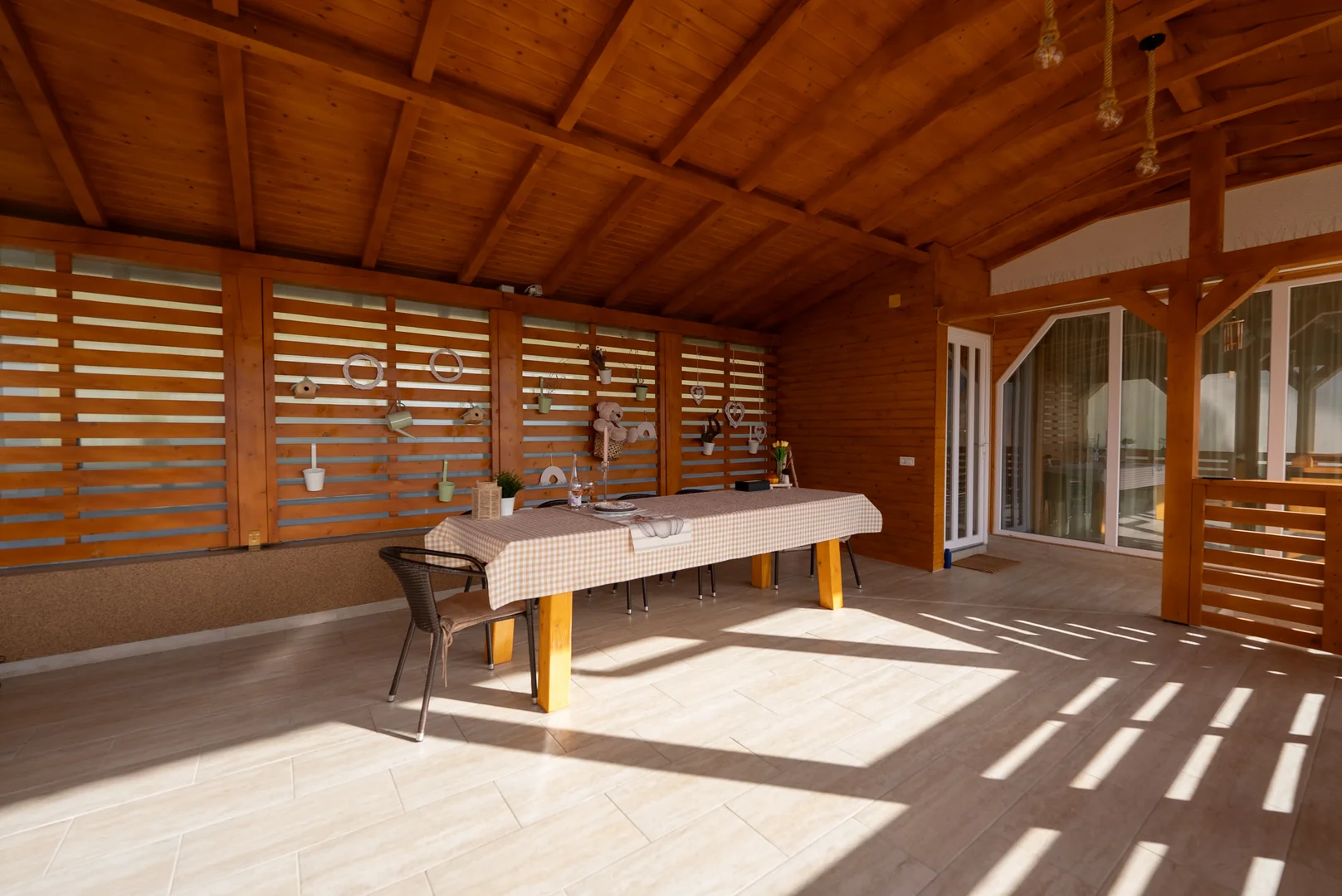 Wooden gazebo with BBQ area and dining spot in the courtyard