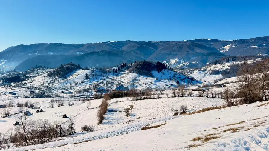 Snow-covered hills and ranges of mountains in clear winter light