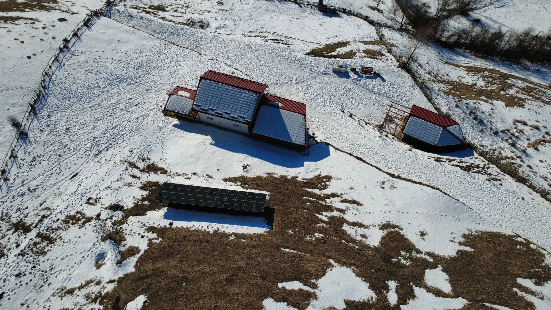 The house and its grounds from a drone, on the snowy land in winter