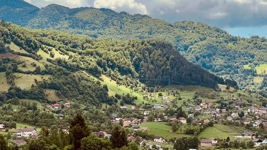 Summer in the Rucăr-Bran Corridor: wooded slopes and village houses in the valley